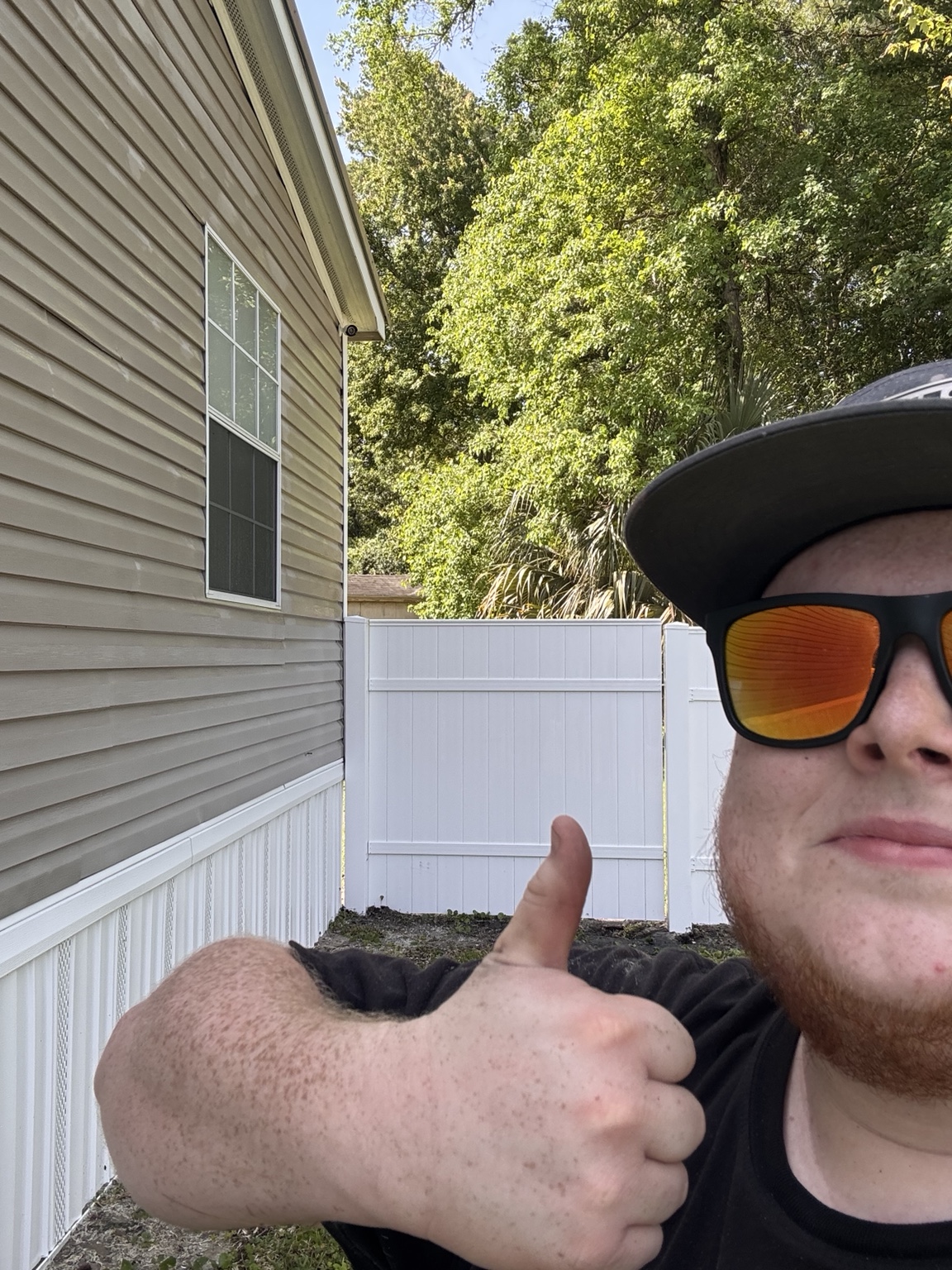 Clean siding and fence area after exterior house washing