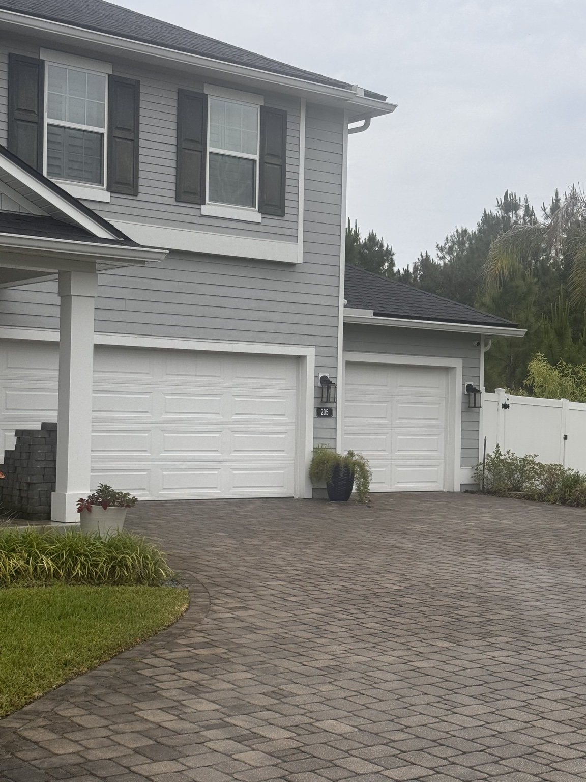Clean paver driveway in front of a two story home